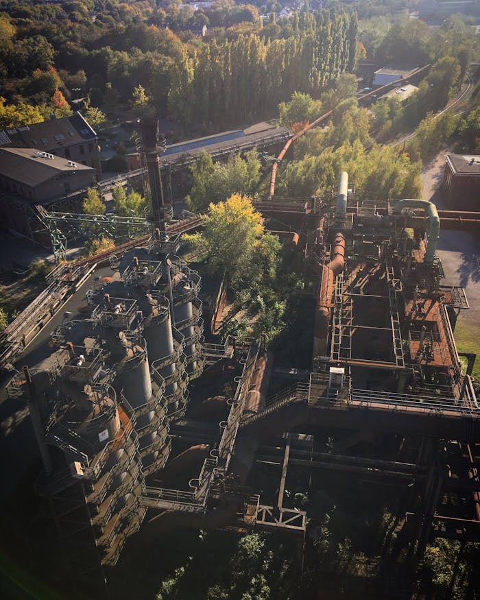 Aerial view of Duisburg Landscape Park, featuring historic industrial structures surrounded by greenery.